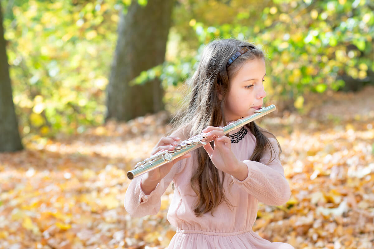 Girl playing the flute outside - improvising in order to love her instrument again